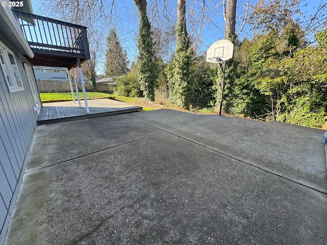 view of basketball court featuring fence