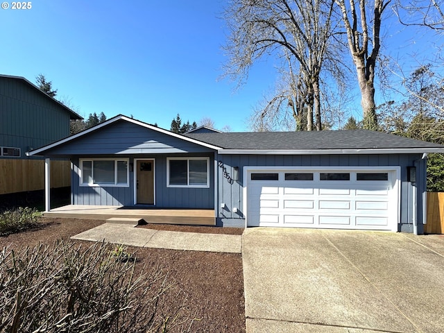 ranch-style home featuring a porch, concrete driveway, a shingled roof, and an attached garage