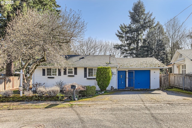 ranch-style house with fence