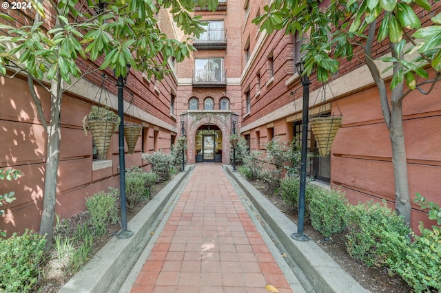 view of exterior entry featuring brick siding