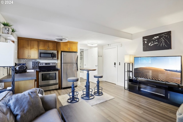 living area featuring visible vents and light wood-style flooring