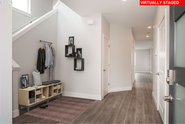 hallway with baseboards, wood finished floors, and recessed lighting