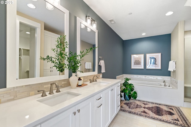 3935 NW 75th Ave, Camas, WA 98607 - full bathroom featuring double vanity, a garden tub, decorative backsplash, and recessed lighting