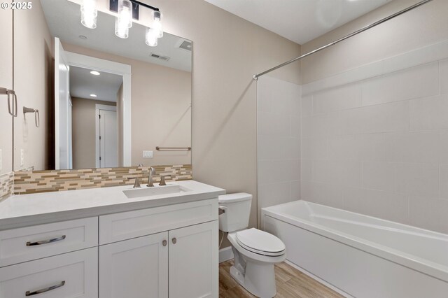 3935 NW 75th Ave, Camas, WA 98607 - full bathroom with vanity, wood finished floors, decorative backsplash, and bathtub / shower combination