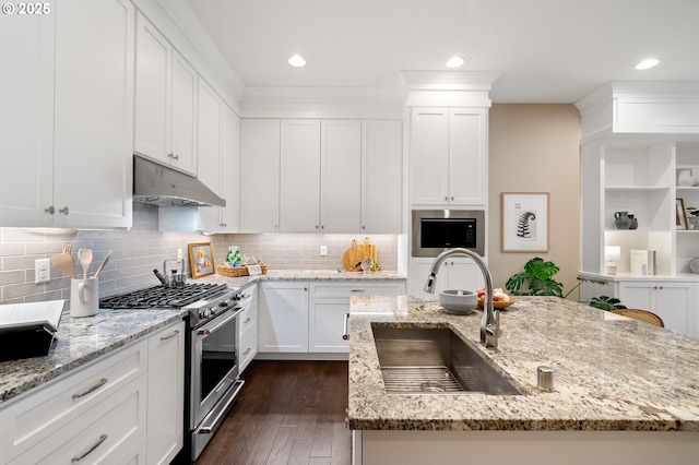 3935 NW 75th Ave, Camas, WA 98607 - kitchen with stainless steel gas range, under cabinet range hood, white cabinets, and recessed lighting