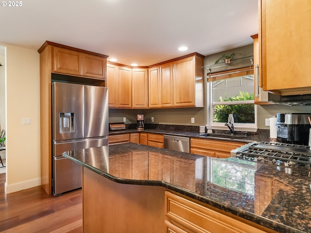 15700 SW Division St, Beaverton, OR 97007 - kitchen featuring appliances with stainless steel finishes, light wood-style floors, recessed lighting, and dark stone counters