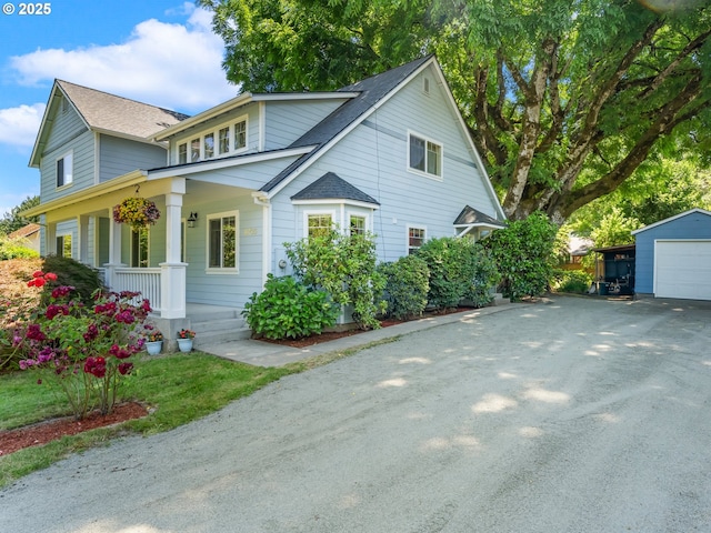 15700 SW Division St, Beaverton, OR 97007 - view of front of home featuring a porch, driveway, a garage, an outdoor structure, and a shingled roof