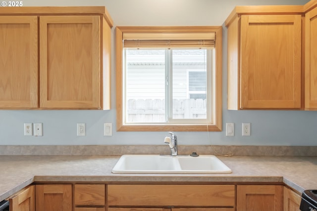 kitchen featuring light countertops, a sink, and electric stove