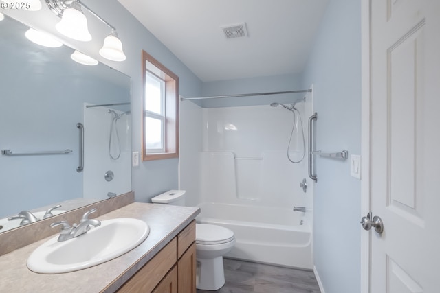 bathroom featuring toilet, shower / tub combination, vanity, and visible vents