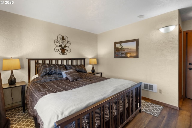 bedroom with dark hardwood / wood-style flooring