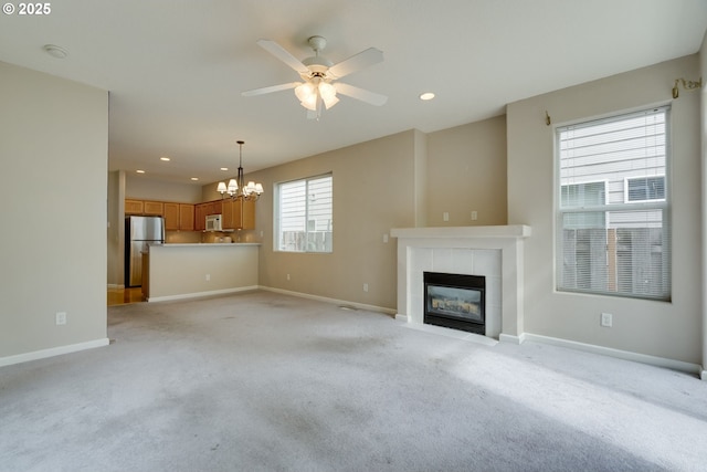 4338 NE 76th Ave, Portland, OR 97218 - unfurnished living room with a chandelier, a fireplace, light colored carpet, recessed lighting, and a ceiling fan