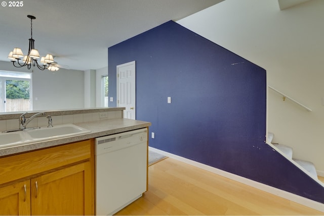 4338 NE 76th Ave, Portland, OR 97218 - kitchen featuring dishwasher, light wood-style flooring, a chandelier, hanging light fixtures, and plenty of natural light