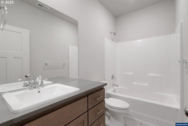 full bathroom featuring toilet, visible vents, shower / washtub combination, and vanity