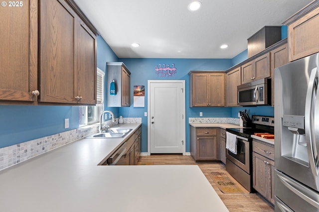 25092 Amber Ct, Veneta, OR 97487 - kitchen featuring stainless steel appliances, a sink, light countertops, light wood finished floors, and recessed lighting