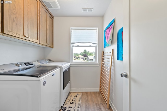 25092 Amber Ct, Veneta, OR 97487 - washroom with washing machine and clothes dryer, cabinet space, baseboards, and light wood-style flooring