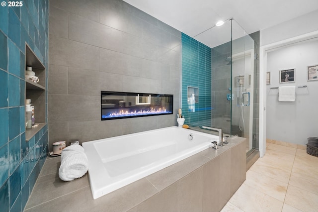 700 Washington St Unit 1125, Vancouver, WA 98660 - bathroom featuring a bath, a shower stall, a fireplace, and tile patterned floors