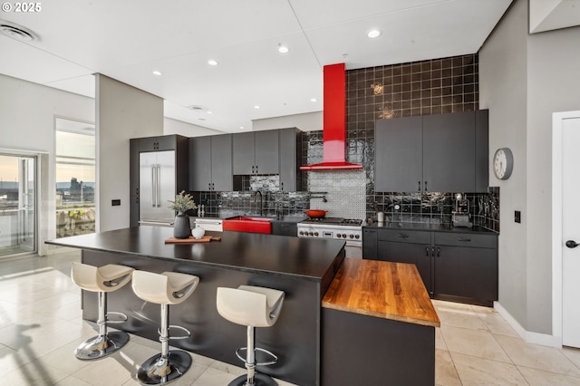700 Washington St Unit 1125, Vancouver, WA 98660 - kitchen with high end stainless steel range oven, tasteful backsplash, recessed lighting, light tile patterned flooring, and a spacious island