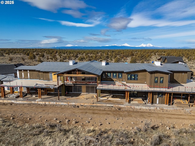 rear view of property featuring a mountain view