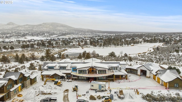 snowy aerial view featuring a mountain view