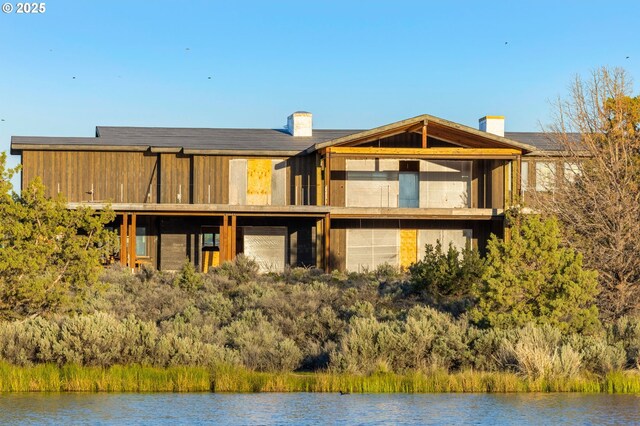 17097 SW Lago Vista Dr, Powell Butte, OR 97753 - rear view of property with a water view and a chimney