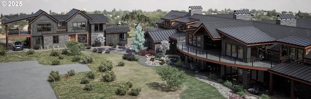 rear view of property featuring stone siding, metal roof, a chimney, a balcony, and a standing seam roof