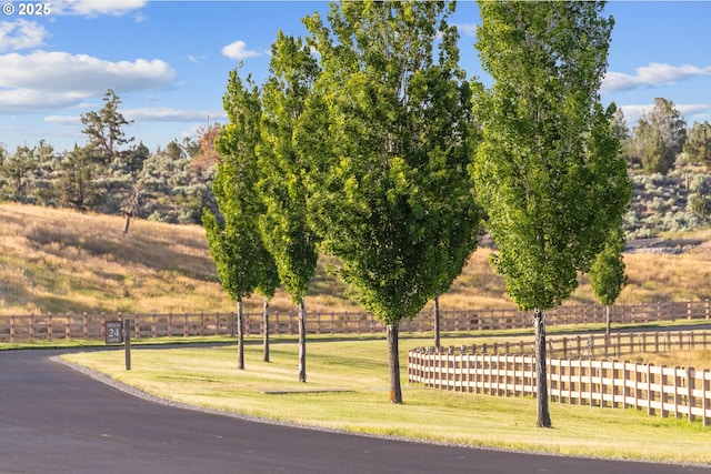 view of community with fence and a lawn