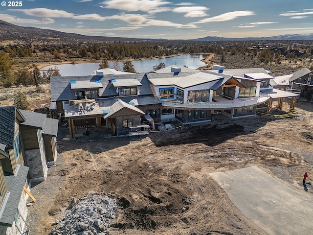 birds eye view of property featuring a water and mountain view