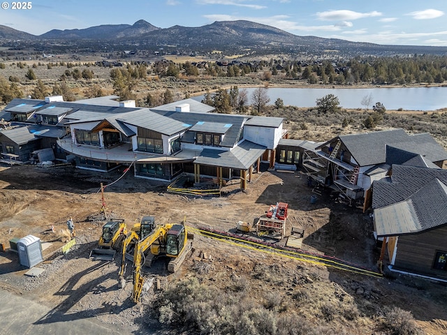 birds eye view of property with a water and mountain view