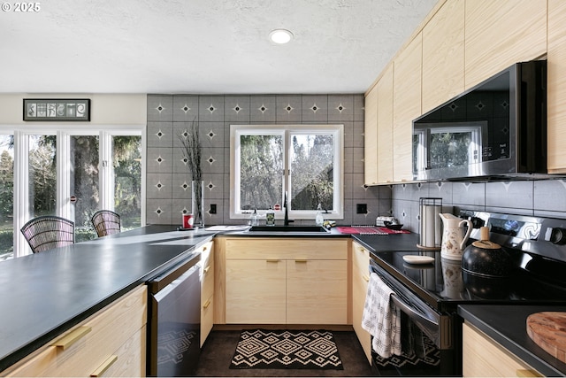 kitchen featuring light brown cabinetry, black range with electric cooktop, plenty of natural light, and a sink