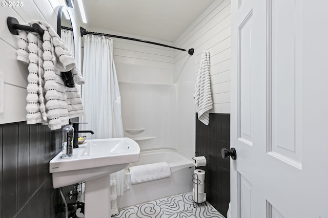 bathroom with shower / tub combo and a sink