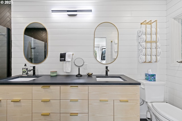 bathroom featuring a sink, toilet, and double vanity