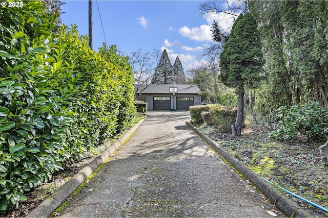 view of property exterior with a garage and an outbuilding