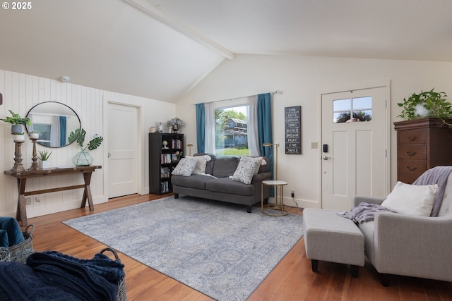 living room with lofted ceiling with beams and wood-type flooring