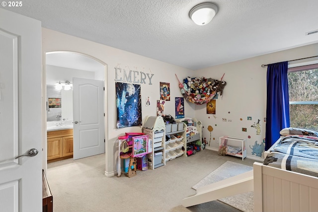 3303 NE 141st St, Vancouver, WA 98686 - carpeted bedroom with a textured ceiling, baseboards, and arched walkways