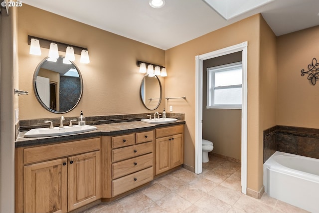 3303 NE 141st St, Vancouver, WA 98686 - full bath featuring double vanity, toilet, a garden tub, tile patterned flooring, and baseboards