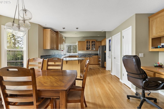 3303 NE 141st St, Vancouver, WA 98686 - dining area featuring light wood-style floors, a desk, and baseboards