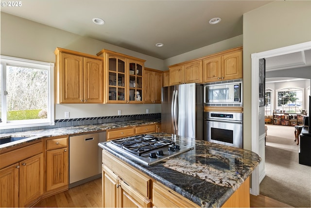 3303 NE 141st St, Vancouver, WA 98686 - kitchen featuring stainless steel appliances, glass insert cabinets, dark stone counters, light wood-style flooring, and recessed lighting