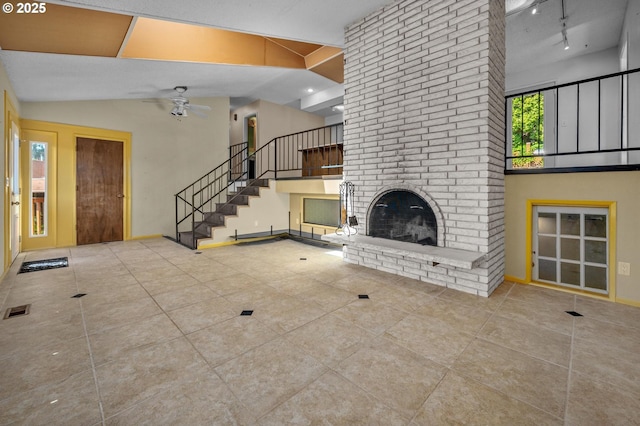 32813 NW Peak Rd, Scappoose, OR 97056 - unfurnished living room with a ceiling fan, tile patterned flooring, stairway, a fireplace, and lofted ceiling