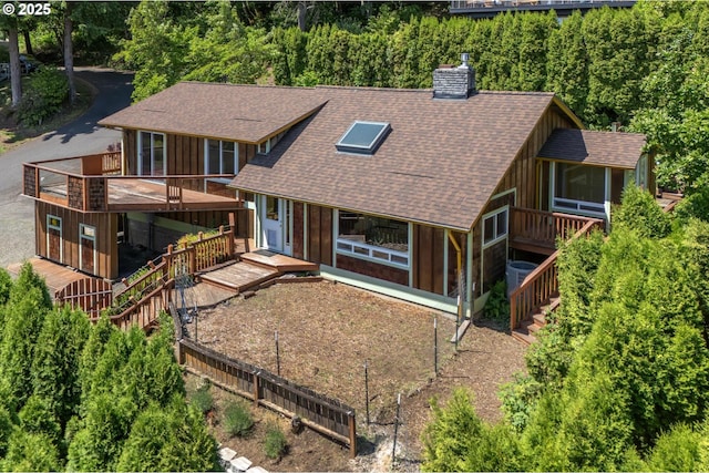 32813 NW Peak Rd, Scappoose, OR 97056 - view of front of home featuring roof with shingles, stairway, a chimney, and a sunroom
