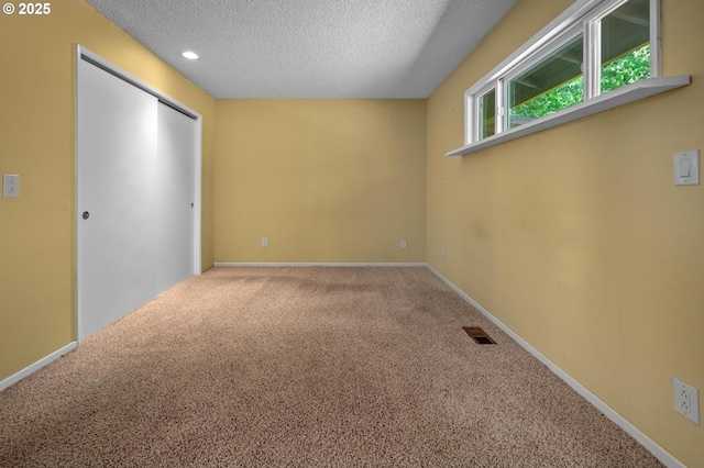 32813 NW Peak Rd, Scappoose, OR 97056 - unfurnished bedroom featuring a textured ceiling, carpet flooring, baseboards, a closet, and recessed lighting