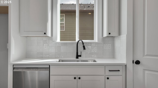 kitchen with dishwasher, decorative backsplash, white cabinetry, and sink