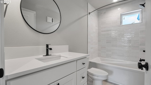 full bathroom featuring vanity, toilet, and tiled shower / bath