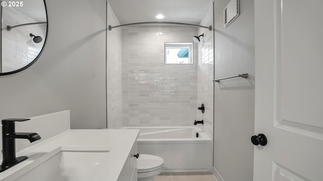 full bathroom featuring toilet, vanity, tiled shower / bath combo, and tile patterned floors