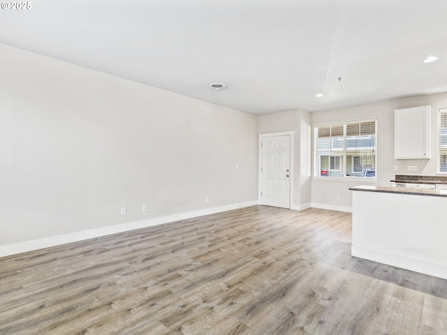 unfurnished living room featuring light hardwood / wood-style floors