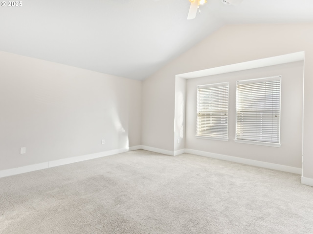 carpeted empty room featuring vaulted ceiling and ceiling fan