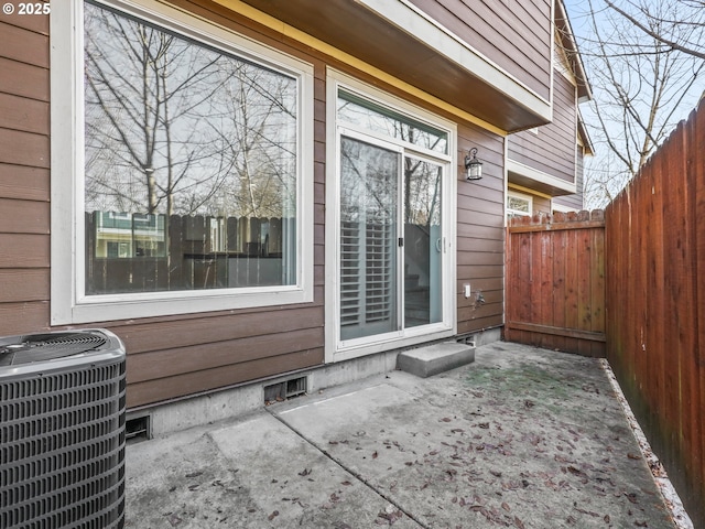 doorway to property with central AC unit and a patio