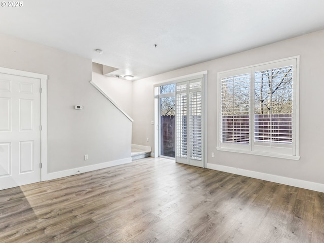 empty room with hardwood / wood-style flooring