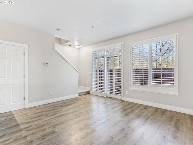 empty room with light hardwood / wood-style floors