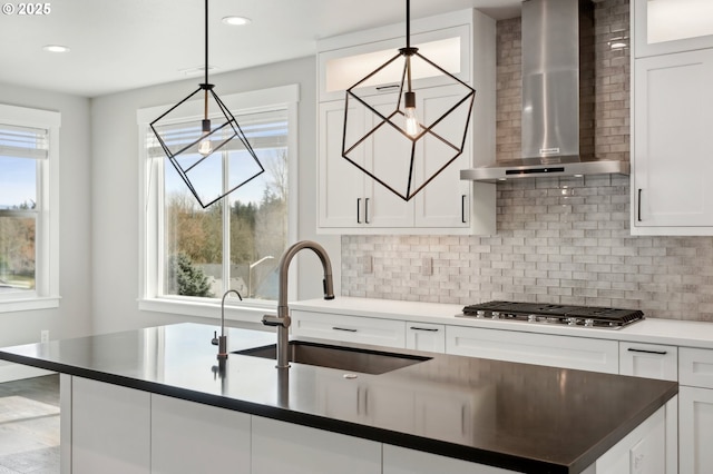1730 N 12th St, Washougal, WA 98671 - kitchen featuring wall chimney exhaust hood, stainless steel gas cooktop, a sink, backsplash, and white cabinetry