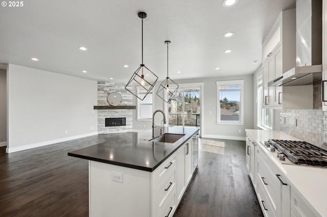 1730 N 12th St, Washougal, WA 98671 - kitchen with a sink, appliances with stainless steel finishes, wall chimney range hood, baseboards, and dark wood-type flooring
